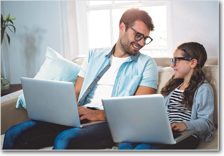 Teen and parent with laptops